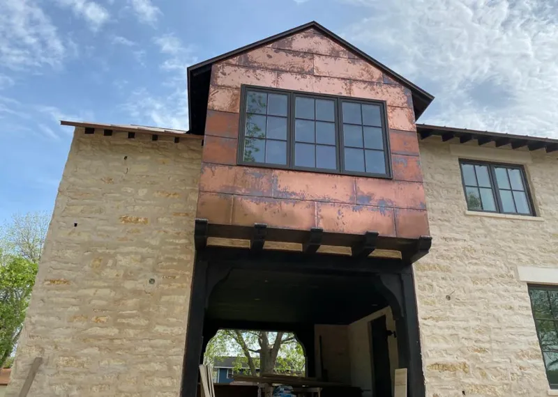 Copper metal panel facade on a stone building for Skylight Installation in Yoakum