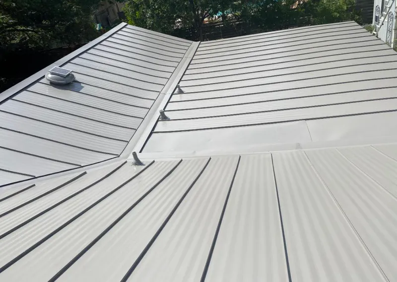Solar attic fan installed on a metal roof for Roof Ventilation in Yoakum
